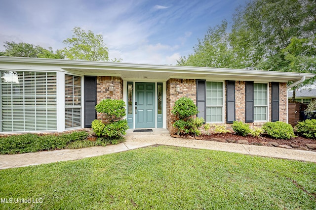 view of front of house with brick siding and a front yard