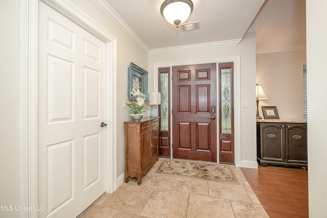 foyer entrance featuring ornamental molding and baseboards