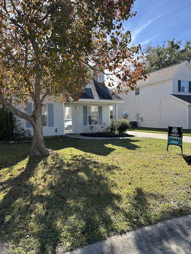 view of front of house featuring a front yard and central AC