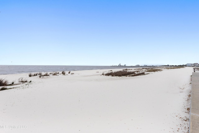 exterior space with a water view and a view of the beach