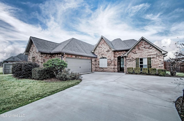 view of front of house featuring a garage and a front lawn