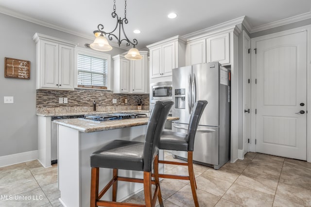 3841 Chateau Cv, Ocean Springs, MS 39564 - kitchen with appliances with stainless steel finishes, backsplash, white cabinetry, light stone counters, and hanging light fixtures