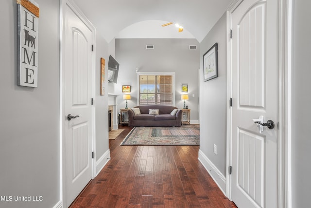 3841 Chateau Cv, Ocean Springs, MS 39564 - hallway featuring dark wood-type flooring, lofted ceiling, and arched walkways