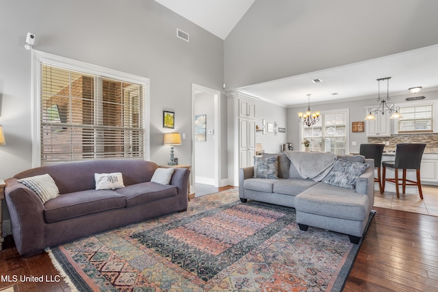 3841 Chateau Cv, Ocean Springs, MS 39564 - living room featuring a chandelier, wood-type flooring, and lofted ceiling
