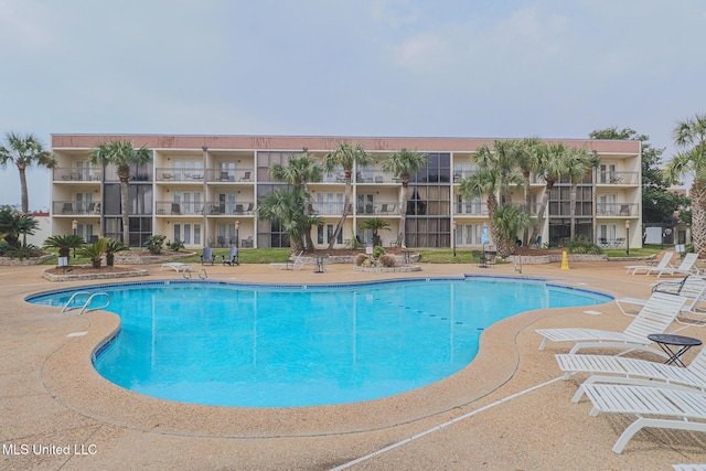 view of swimming pool with a patio area