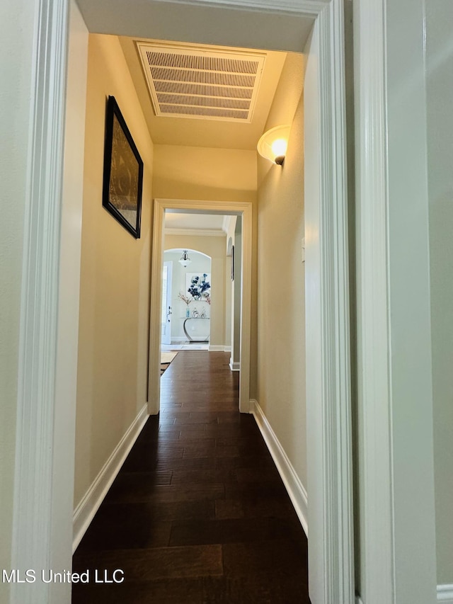 3936 David Ln, Diberville, MS 39540 - hallway with arched walkways, baseboards, and dark wood finished floors