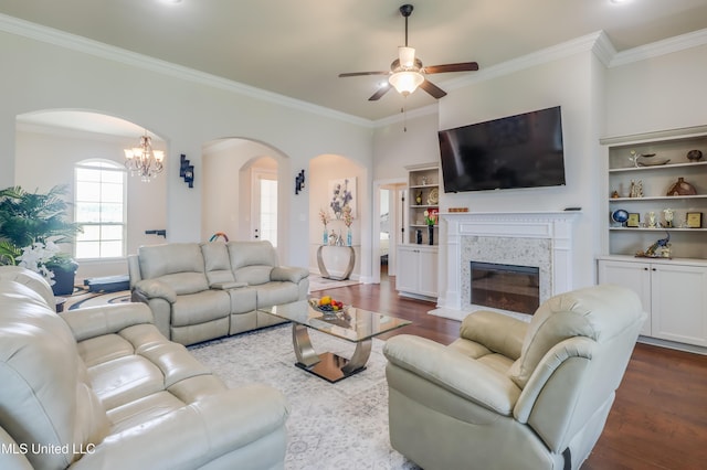 3936 David Ln, Diberville, MS 39540 - living room featuring arched walkways, ceiling fan, dark wood-style flooring, crown molding, and a chandelier