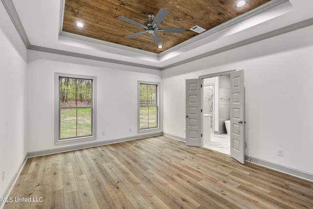 unfurnished bedroom featuring ornamental molding, wood ceiling, a tray ceiling, and light wood-type flooring