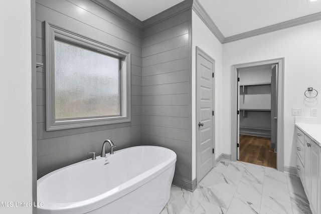 bathroom featuring vanity, a bathtub, and ornamental molding