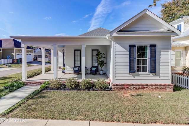 view of front of home with a porch and a front lawn