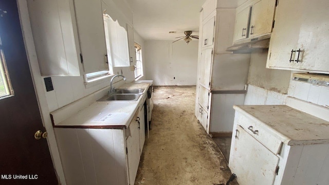 kitchen featuring ceiling fan, sink, and white cabinets