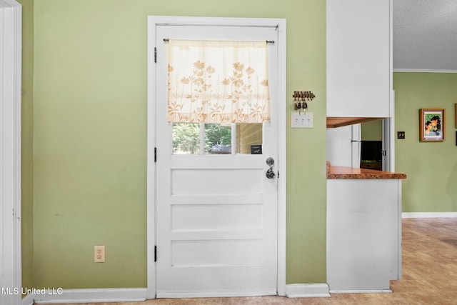 530 Oakhurst Dr, Hernando, MS 38632 - doorway to outside featuring baseboards and a textured ceiling
