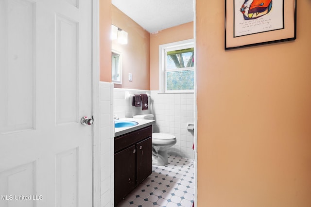 530 Oakhurst Dr, Hernando, MS 38632 - bathroom with tile walls, vanity, wainscoting, and tile patterned flooring
