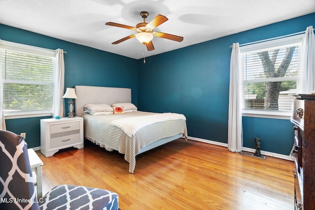 530 Oakhurst Dr, Hernando, MS 38632 - bedroom featuring light wood-style floors, ceiling fan, and a textured ceiling