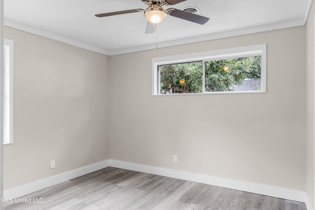 spare room with light hardwood / wood-style floors, crown molding, and ceiling fan