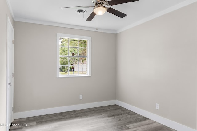 empty room with ceiling fan, crown molding, and hardwood / wood-style floors