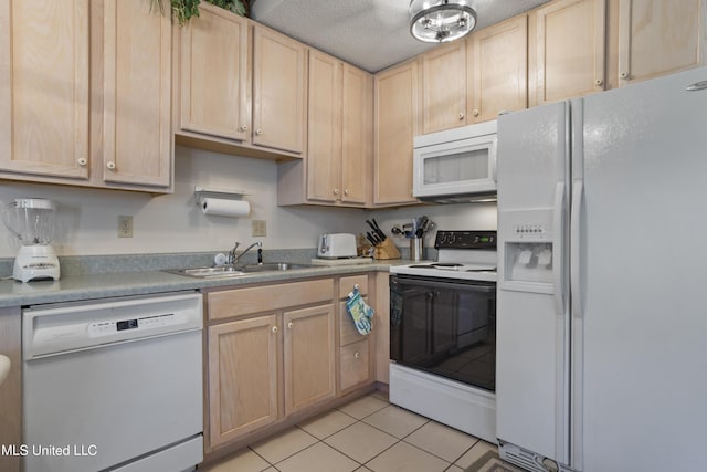 kitchen featuring light brown cabinetry, a sink, light tile patterned floors, light countertops, and white appliances