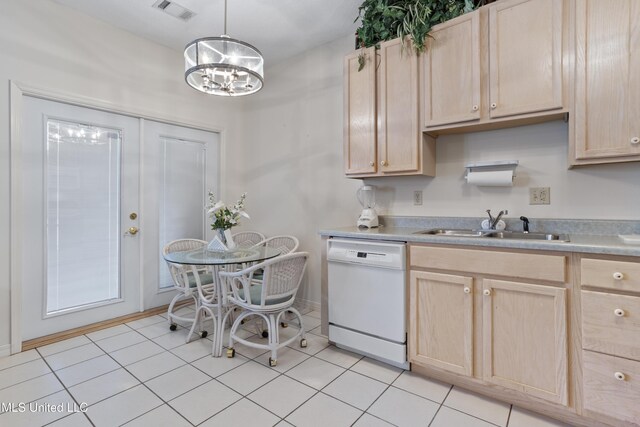 kitchen featuring visible vents, white dishwasher, and light brown cabinetry