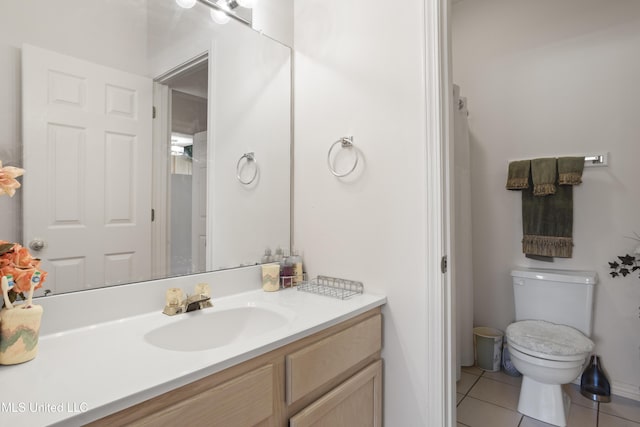 bathroom with vanity, tile patterned flooring, and toilet