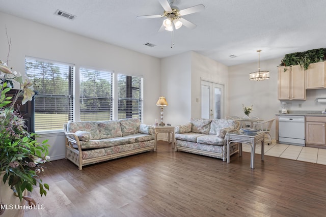 living room with visible vents, light wood finished floors, and a wealth of natural light