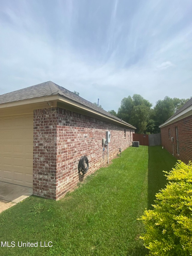 view of home's exterior featuring cooling unit and a lawn