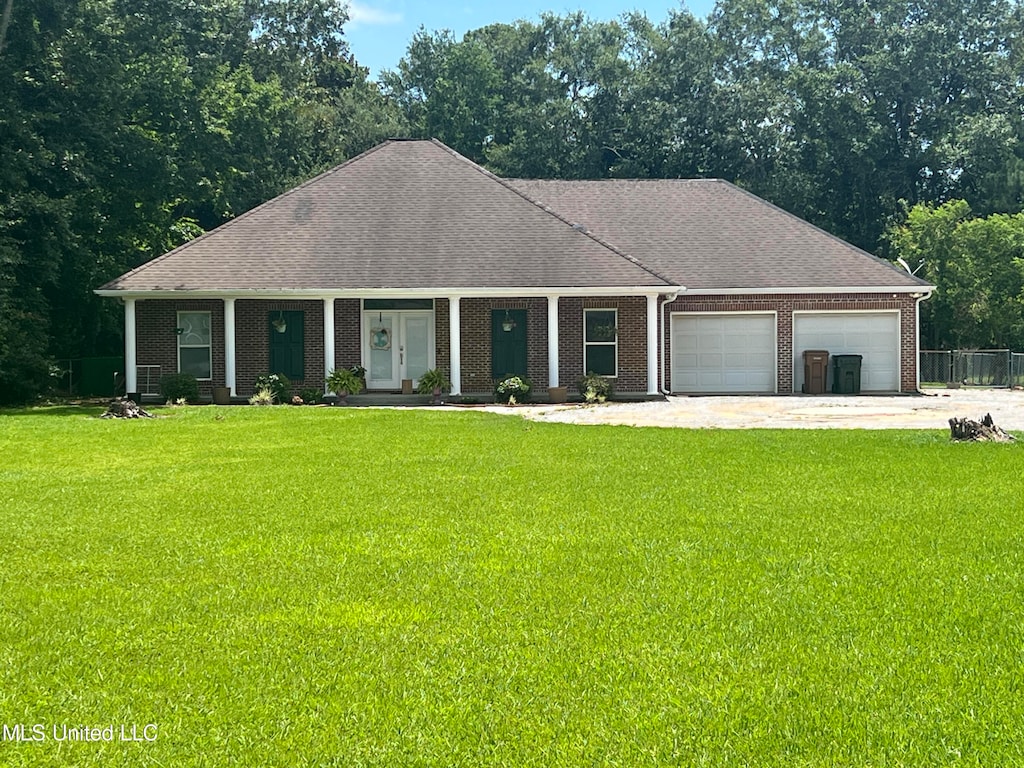 ranch-style home with a porch, a front lawn, and a garage