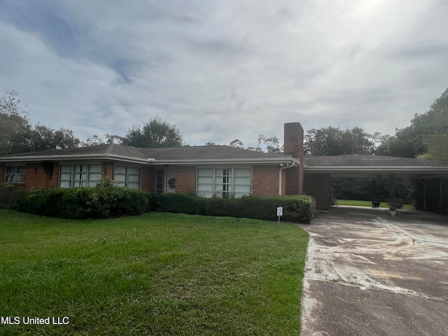 single story home featuring a front yard and a carport