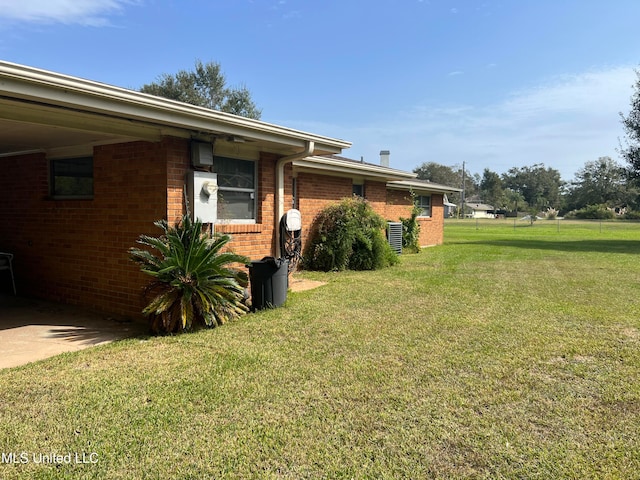 view of home's exterior with a lawn