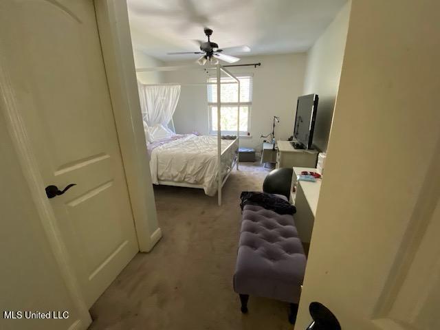 carpeted bedroom with a ceiling fan