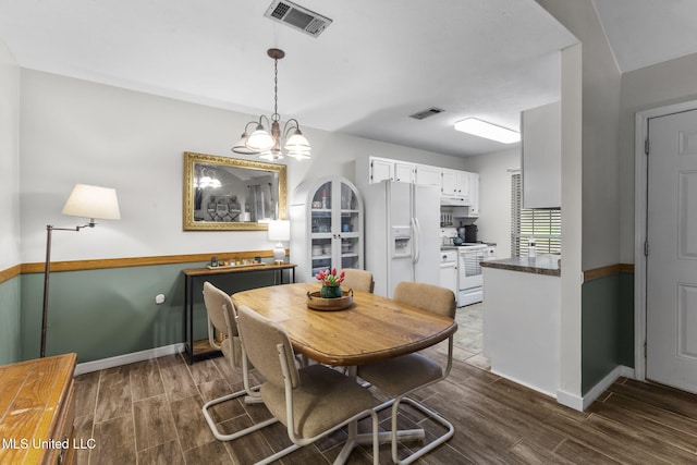 7012 Copper Cv, Ridgeland, MS 39157 - dining room with dark wood-style floors, baseboards, and a chandelier