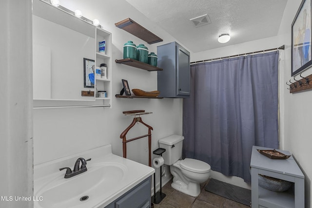 7012 Copper Cv, Ridgeland, MS 39157 - full bathroom with vanity, a textured ceiling, toilet, curtained shower, and tile patterned flooring