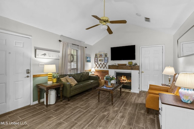 7012 Copper Cv, Ridgeland, MS 39157 - living area featuring a ceiling fan, dark wood-style flooring, vaulted ceiling, a fireplace with flush hearth, and baseboards