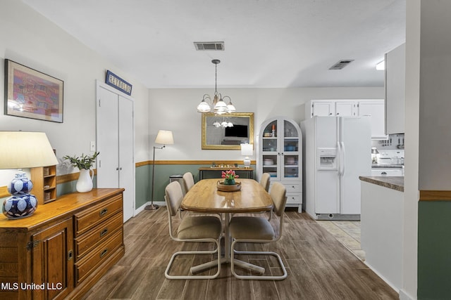 7012 Copper Cv, Ridgeland, MS 39157 - dining space with dark wood-style flooring, a chandelier, and baseboards