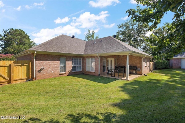 205 Stonebriar Ln, Brandon, MS 39042 - rear view of house featuring a patio, a shingled roof, and brick siding