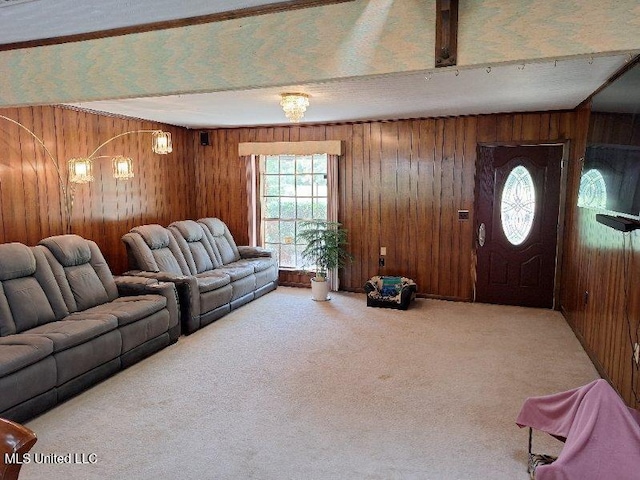 carpeted living room featuring wooden walls