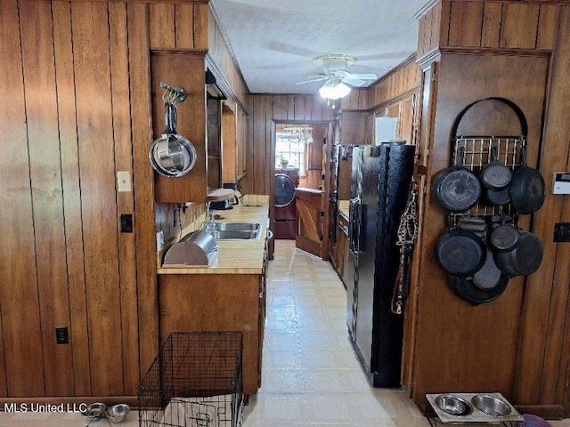 hall with sink and wood walls