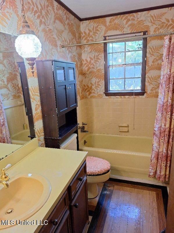 full bathroom featuring shower / tub combo with curtain, toilet, vanity, crown molding, and hardwood / wood-style flooring