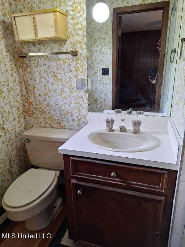 bathroom featuring vanity and toilet