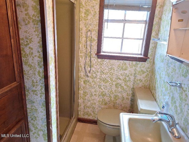 bathroom featuring toilet, walk in shower, and sink