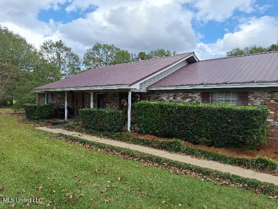 view of side of home featuring a lawn