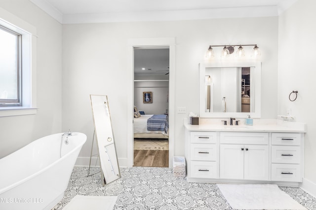 bathroom with vanity, ceiling fan, crown molding, and a tub