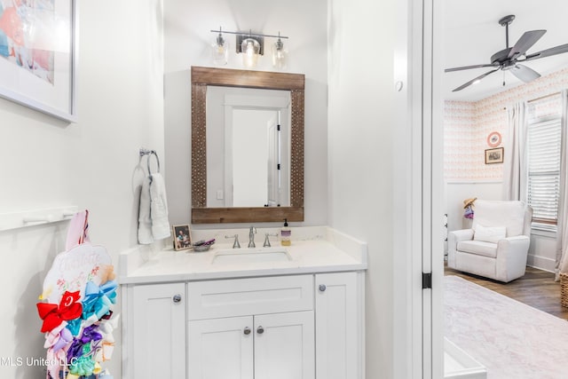 bathroom with hardwood / wood-style floors, vanity, and ceiling fan