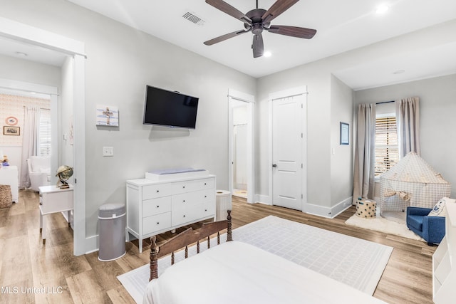 bedroom featuring a closet, light hardwood / wood-style floors, and ceiling fan