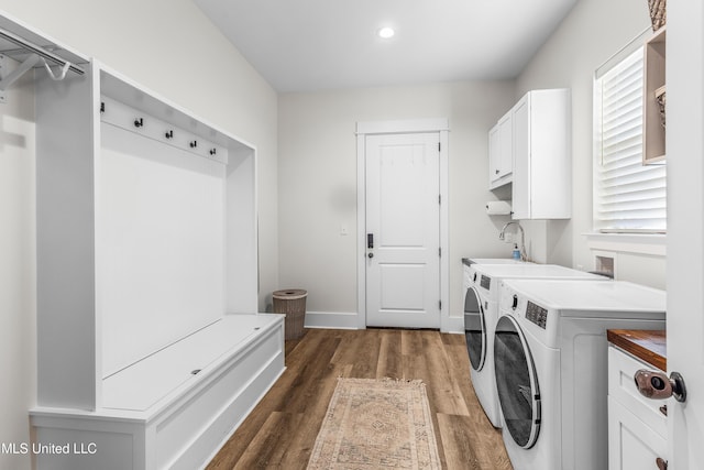 laundry area with cabinets, dark hardwood / wood-style flooring, and separate washer and dryer