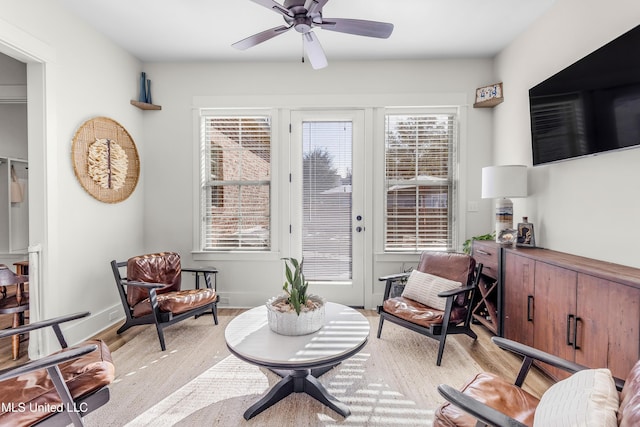 sitting room with ceiling fan and light hardwood / wood-style floors