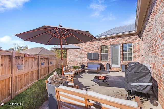 view of patio featuring area for grilling and an outdoor living space with a fire pit