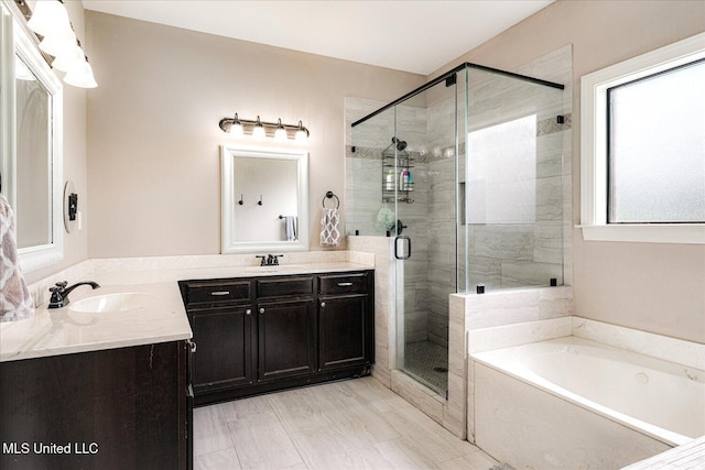 6865 Payne Ln, Olive Branch, MS 38654 - bathroom featuring vanity, a bath, and a stall shower