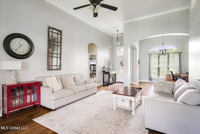 6865 Payne Ln, Olive Branch, MS 38654 - living area featuring arched walkways, a ceiling fan, a chandelier, wood finished floors, and a towering ceiling