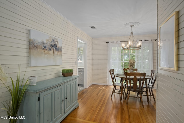 dining room with a chandelier and light hardwood / wood-style floors