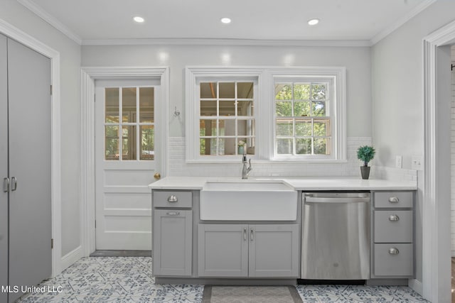 interior space with tasteful backsplash, dishwasher, ornamental molding, gray cabinets, and sink